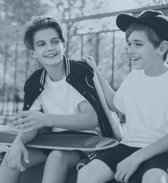 Two boys hanging out at skate park